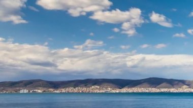 View of magical brilliant bewitching reflection in calm blue quiet Black Sea, against background of sea horizon with cloudy multi-colored sky and bright evening sunset. 4K UHD timelapse video