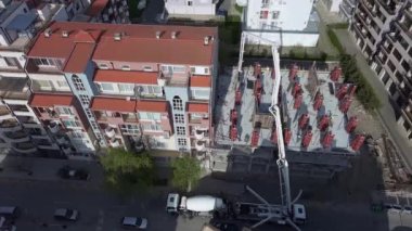 Birds eye view of diligent construction of multi-storey resort apartments in residential area with empty streets near sea beach of Black Sea in town of Pomorie, Bulgaria. UHD 4K video realtime