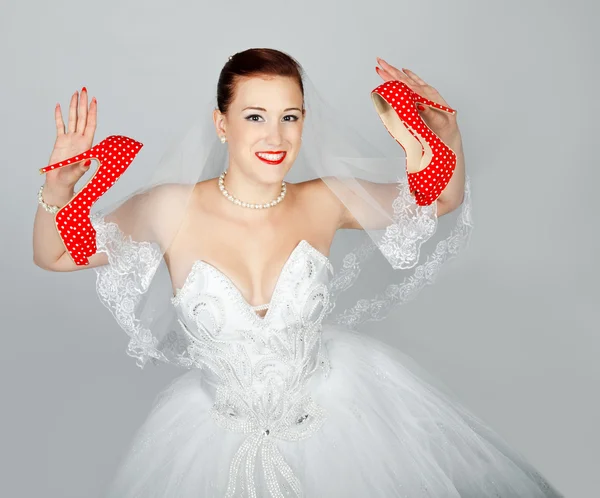 Portrait of young beautiful bride with red shoes — Stock Photo, Image