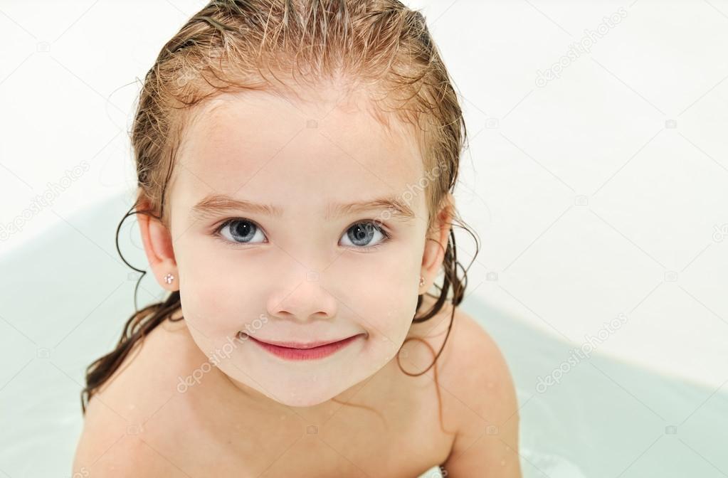 Cute small girl is taking a bath