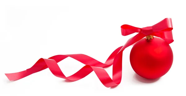 Red christmas ball with ribbon on a white — Stock Photo, Image