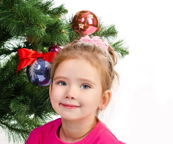 Smiling cute little girl near the Christmas tree isolated — Stock Photo, Image