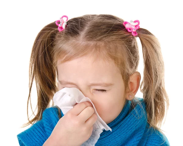 Little girl blowing her nose in a great effort closeup isolated — Stock Photo, Image