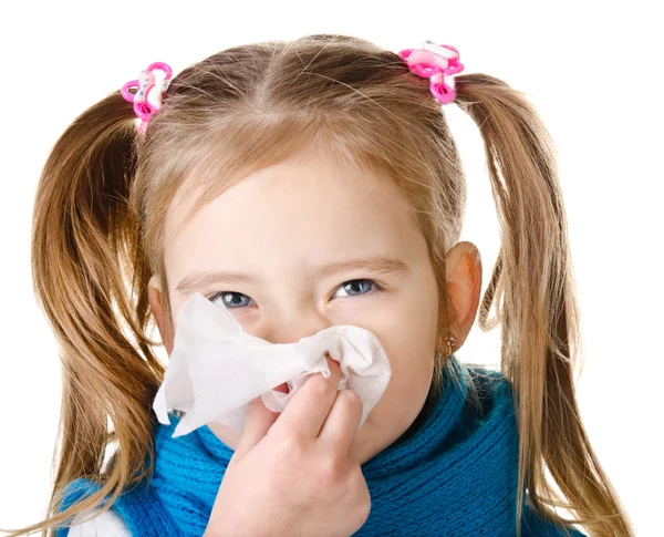 Little girl blowing her nose in a great effort closeup isolated — Stock Photo, Image