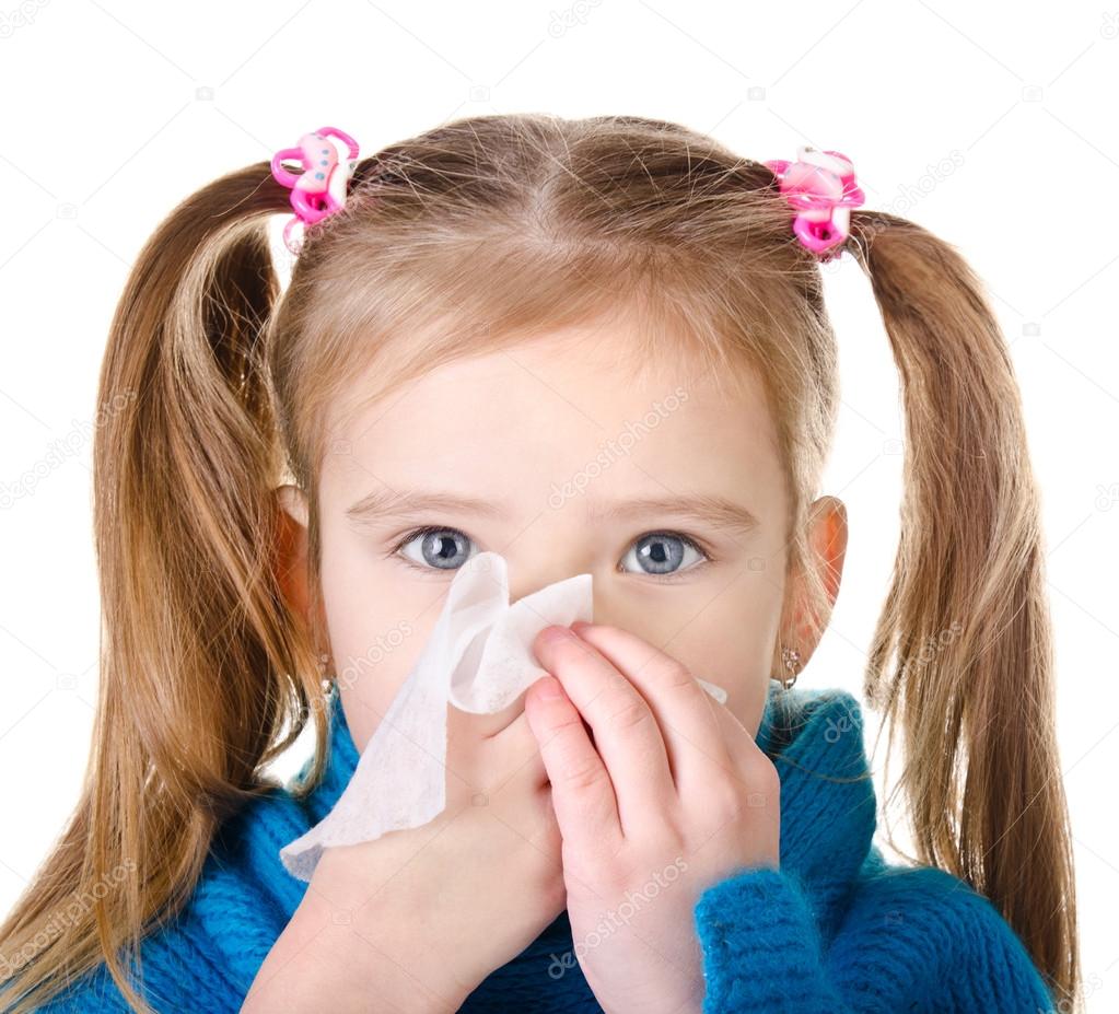 Little girl blowing her nose closeup isolated