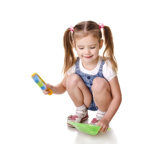 Cute little girl sweeps a floor isolated — Stock Photo, Image