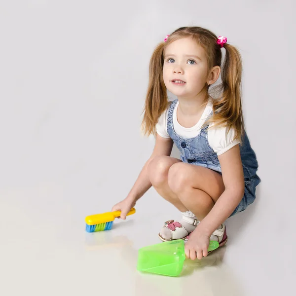 Cute little girl sweeps a floor — Stock Photo, Image