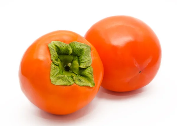 Twee oranje rijp persimmon geïsoleerd — Stockfoto