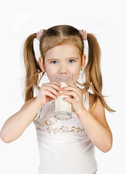 Cute little girl is drinking milk isolated — Stock Photo, Image