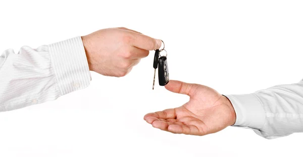 Male hand holding a car key and handing it over to another perso — Stock Photo, Image