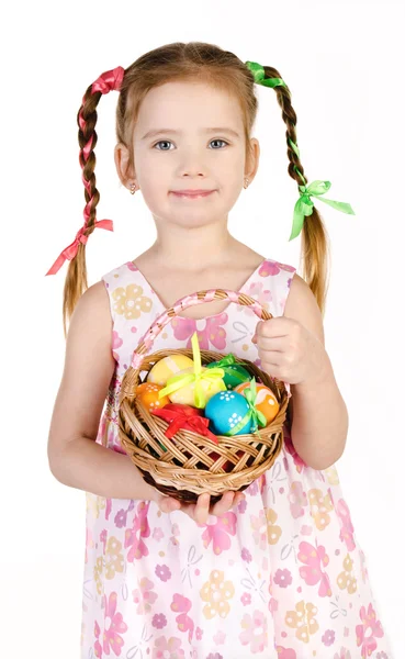 Smiling little girl with basket full of colorful easter eggs iso — Stock Photo, Image