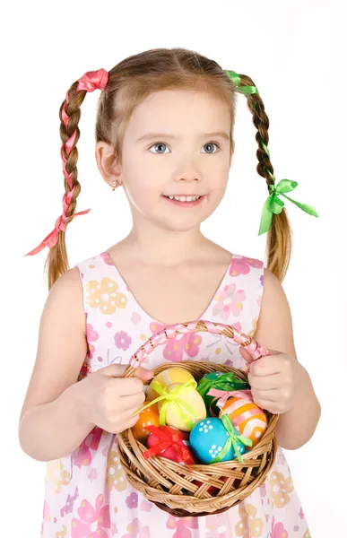 Smiling little girl with basket full of colorful easter eggs iso — Stock Photo, Image