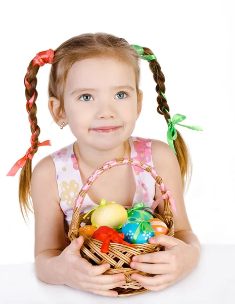 Smiling little girl with basket full of colorful easter eggs iso — Stock Photo, Image