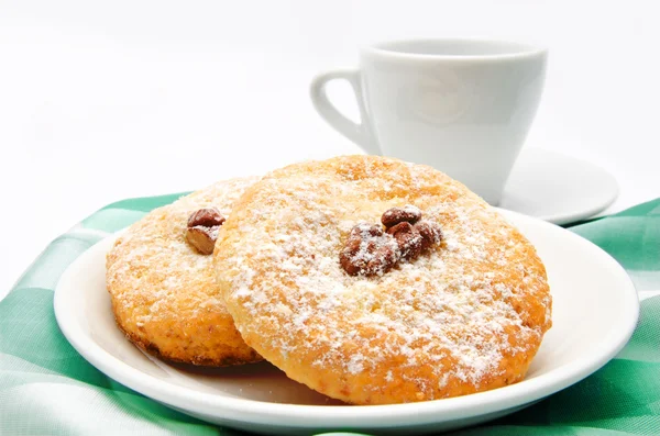 Delicious cookies on a plate and cup of tea isolated — Stock Photo, Image