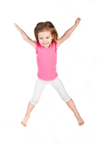 Adorable little girl jumping in air isolated — Stock Photo, Image