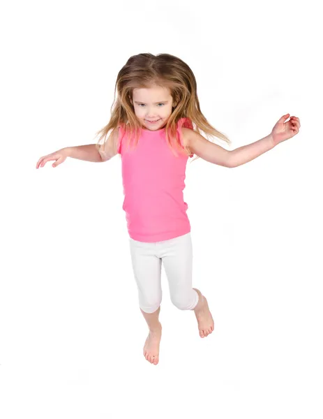 Entzückendes kleines Mädchen, das isoliert in die Luft springt — Stockfoto