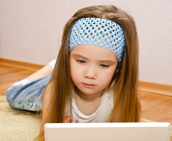 Meisje met een laptop thuis op de verdieping — Stockfoto