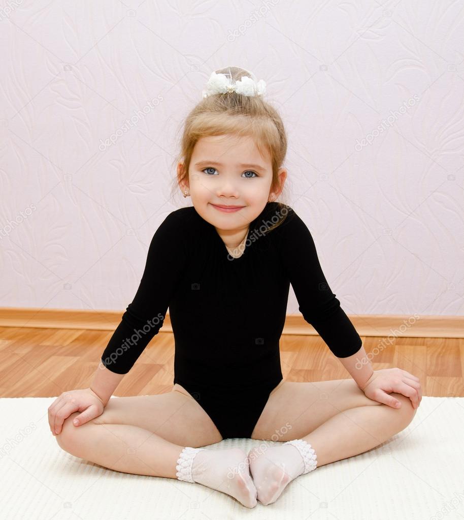 Gymnast cute little girl doing exercises