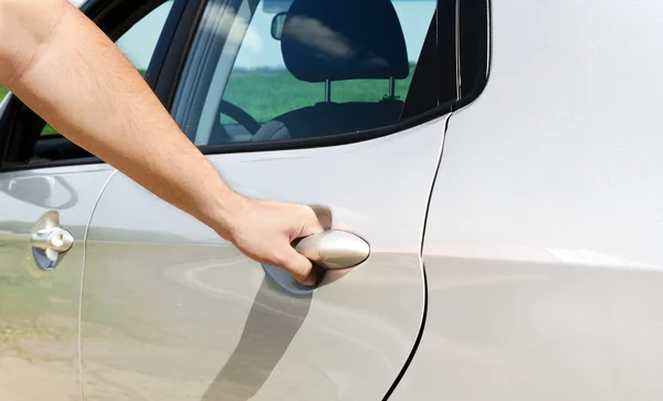 Man opens the door to a new car — Stock Photo, Image