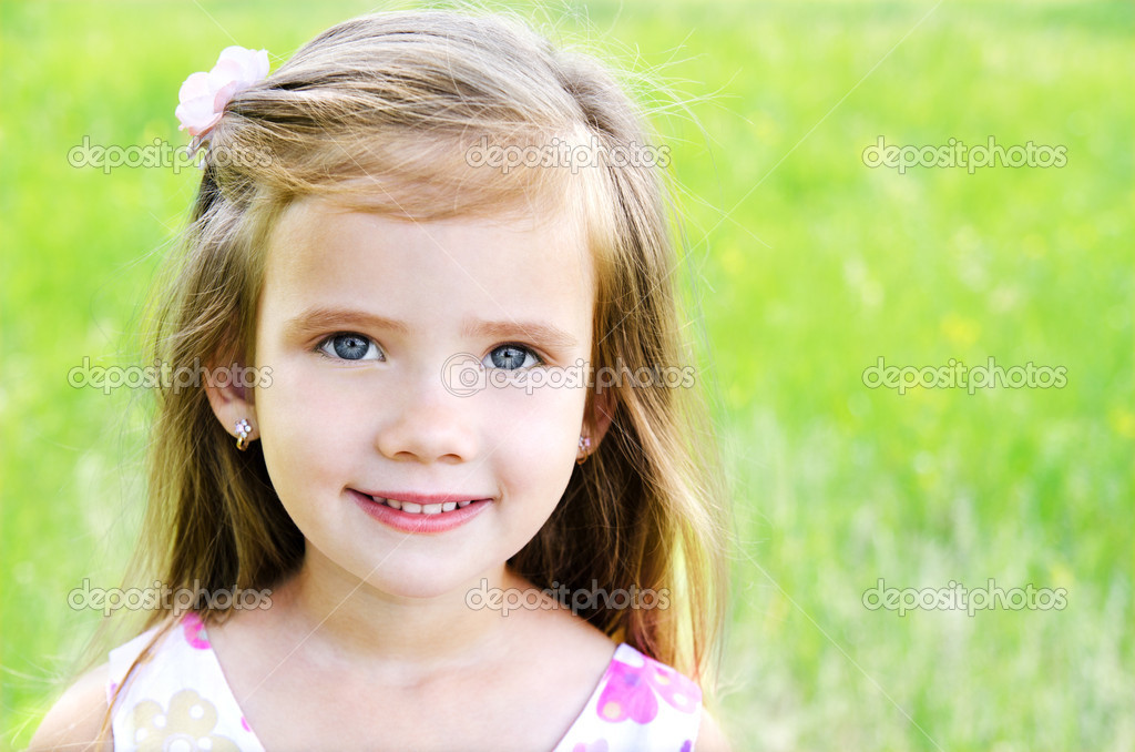 Cute smiling little girl on the meadow Stock Photo by ©svetamart 26656753
