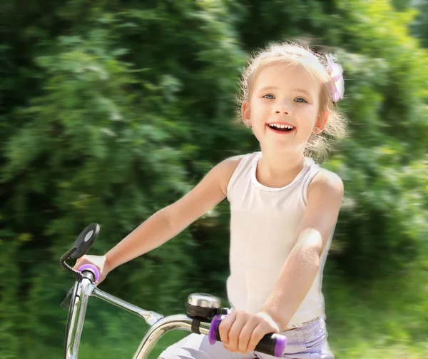 Smiling cute little girl with her bicycle — Stock Photo, Image