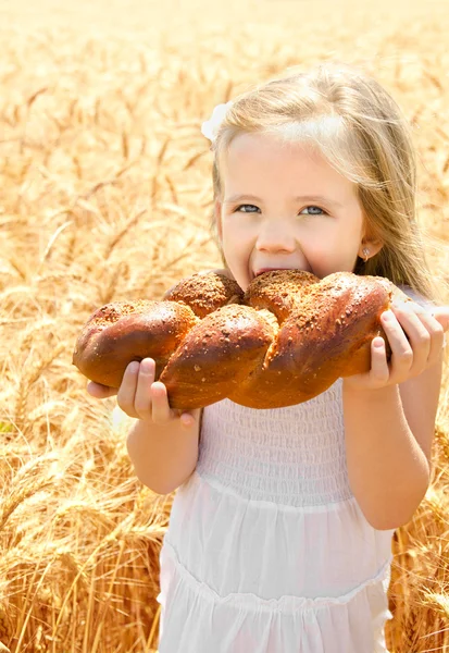 Cute little girl eating bread