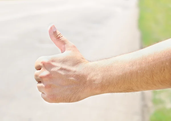 Male hand hitchhiking — Stock Photo, Image
