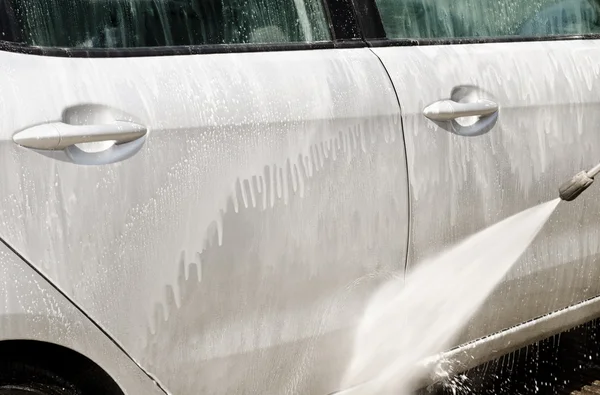 Manual car washing cleaning with foam and pressured water at ser — Stock Photo, Image