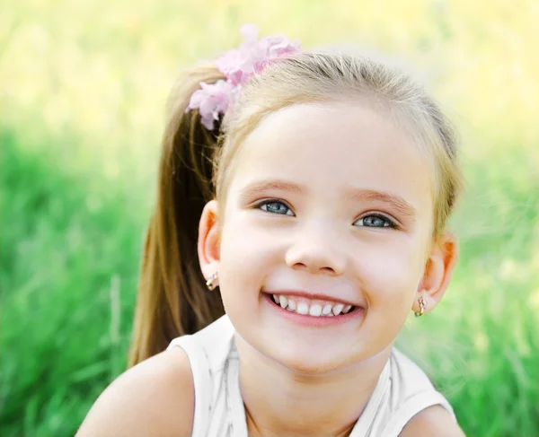 Cute happy little girl on the meadow — Stock Photo, Image