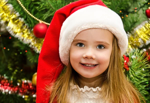 Little girl in santa hat with present have a christmas Stock Image