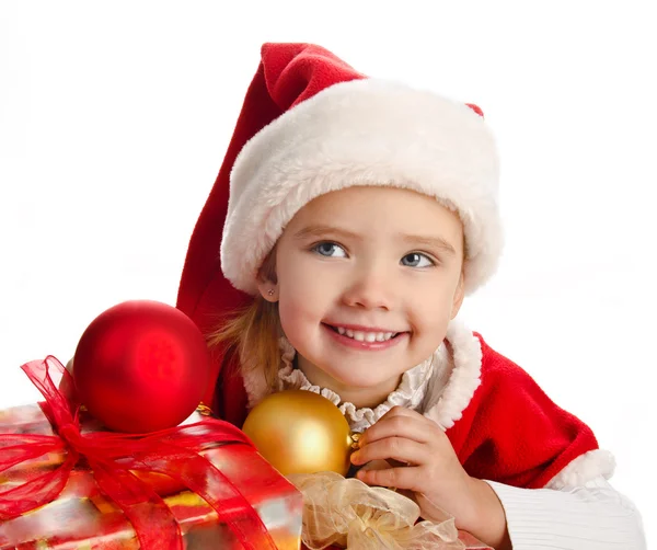 Little girl in christmas hat with gift box and balls Royalty Free Stock Photos