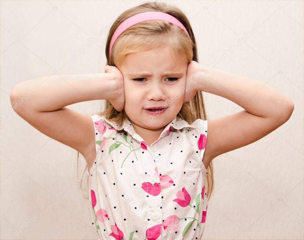 Little girl covering her ears