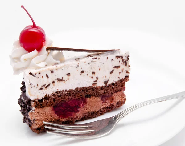 Slice of chocolate cake with cherry on the top isolated Royalty Free Stock Photos