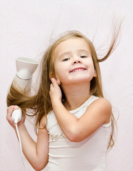 Cute smiling Little girl dries hair — Stock Photo, Image