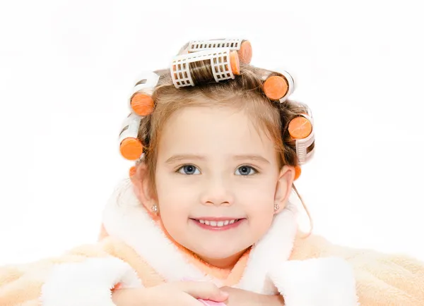 Portrait of smiling cute little girl in hair curlers and bathrob — Stock Photo, Image