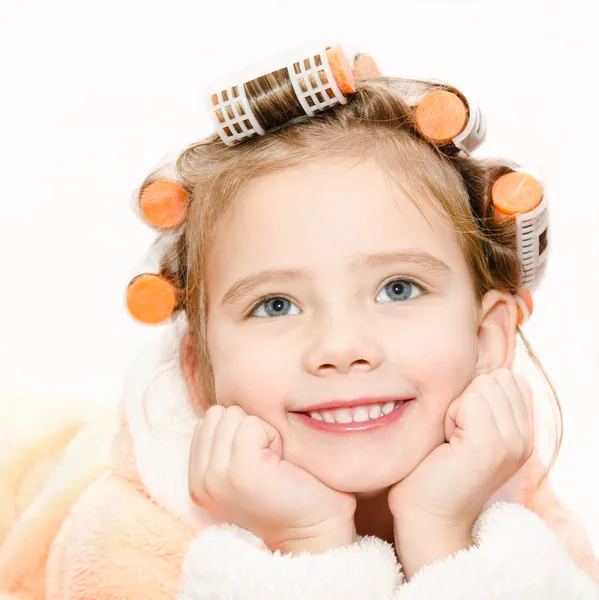 Portrait of smiling cute little girl in hair curlers and bathrob — Stock Photo, Image