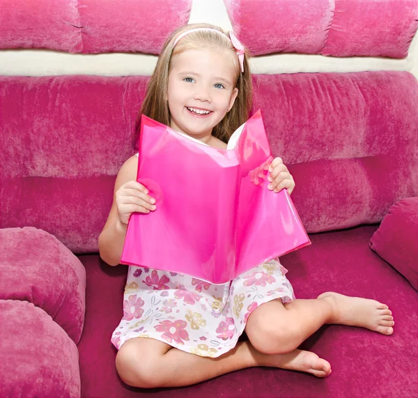 Cute happy little girl reading a book — Stock Photo, Image