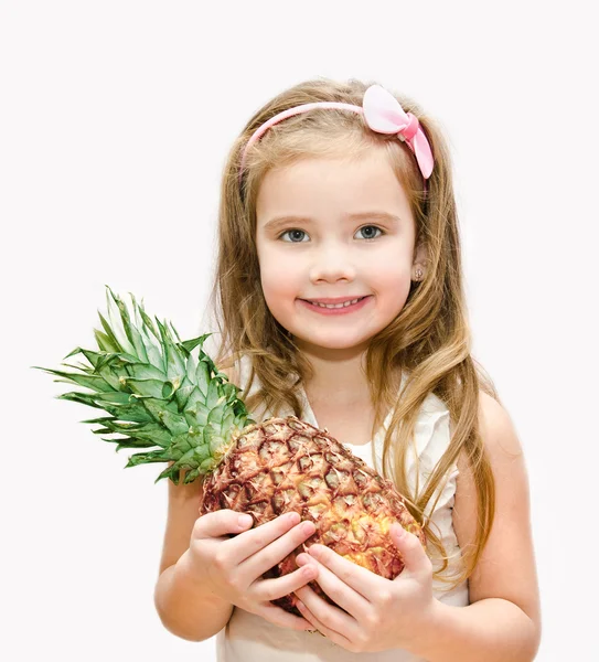 Smiling cute little girl holding ripe whole pineapple — Stock Photo, Image