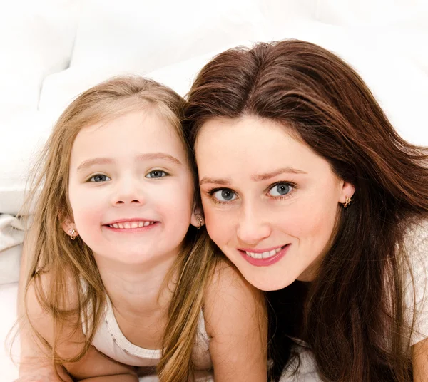 Smiling mother and her little girl playing together — Stock Photo, Image