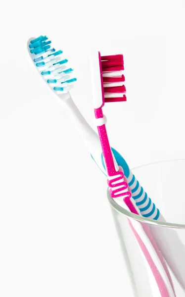 Two toothbrushes in glass isolated on white background — Stock Photo, Image