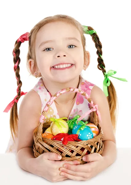 Smiling little girl with basket full of colorful easter eggs iso — Stock Photo, Image