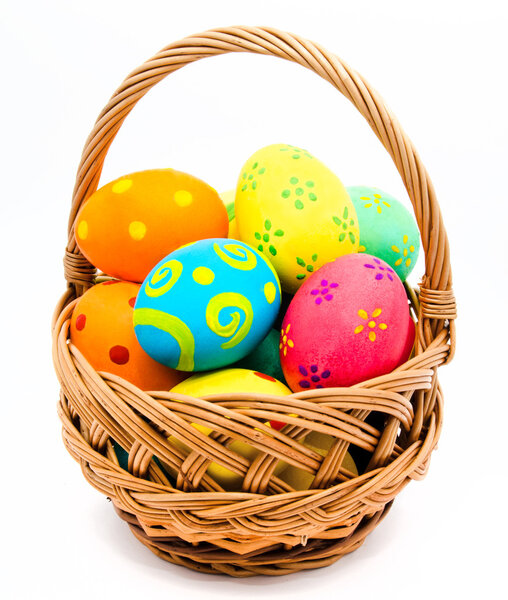 Colorful handmade easter eggs in the basket isolated on a white Stock Photo