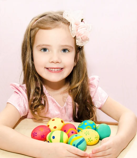 Smiling little girl with colorful easter eggs — Stock Photo, Image