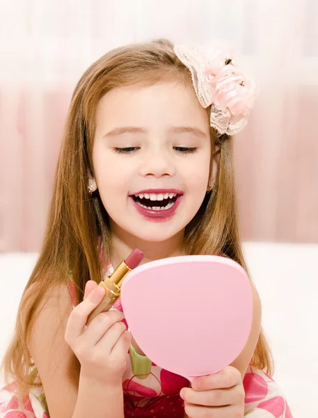 Little girl with lipstick and  mirror — Stock Photo, Image