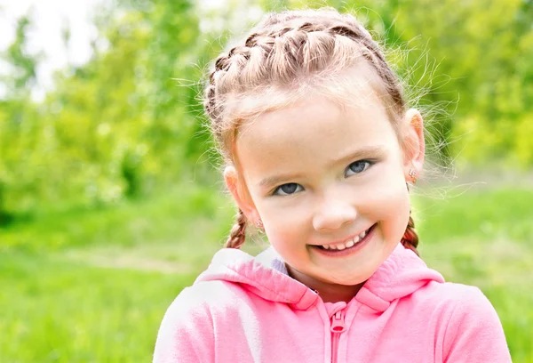 Ritratto di adorabile sorridente bambina sul prato — Foto Stock