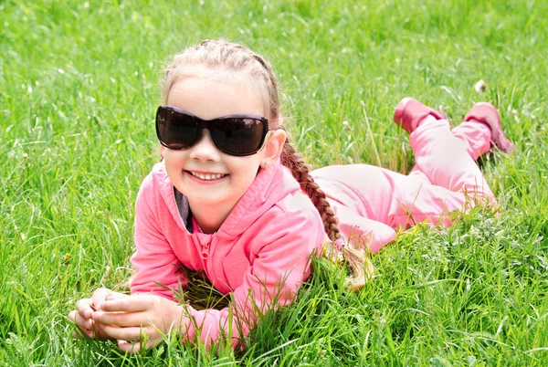 サングラスに横たわっている愛らしい笑顔少女の肖像画 — ストック写真