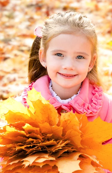 Autumn portrait of cute smiling little girl with maple leaves — Stock Photo, Image