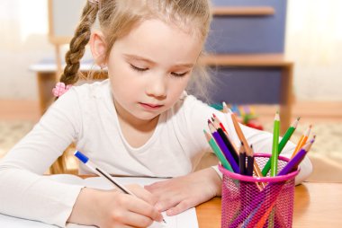 sevimli küçük kız masa başında yazma