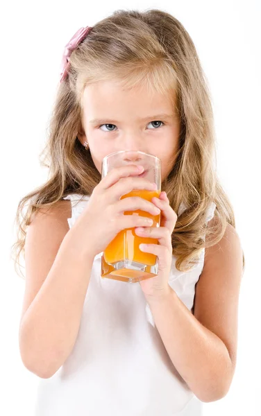 Cute little girl drinking orange juice isolated — Stock Photo, Image