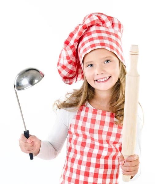 Ler söt liten flicka i kocken hatt med slev och rullande pin — Stockfoto